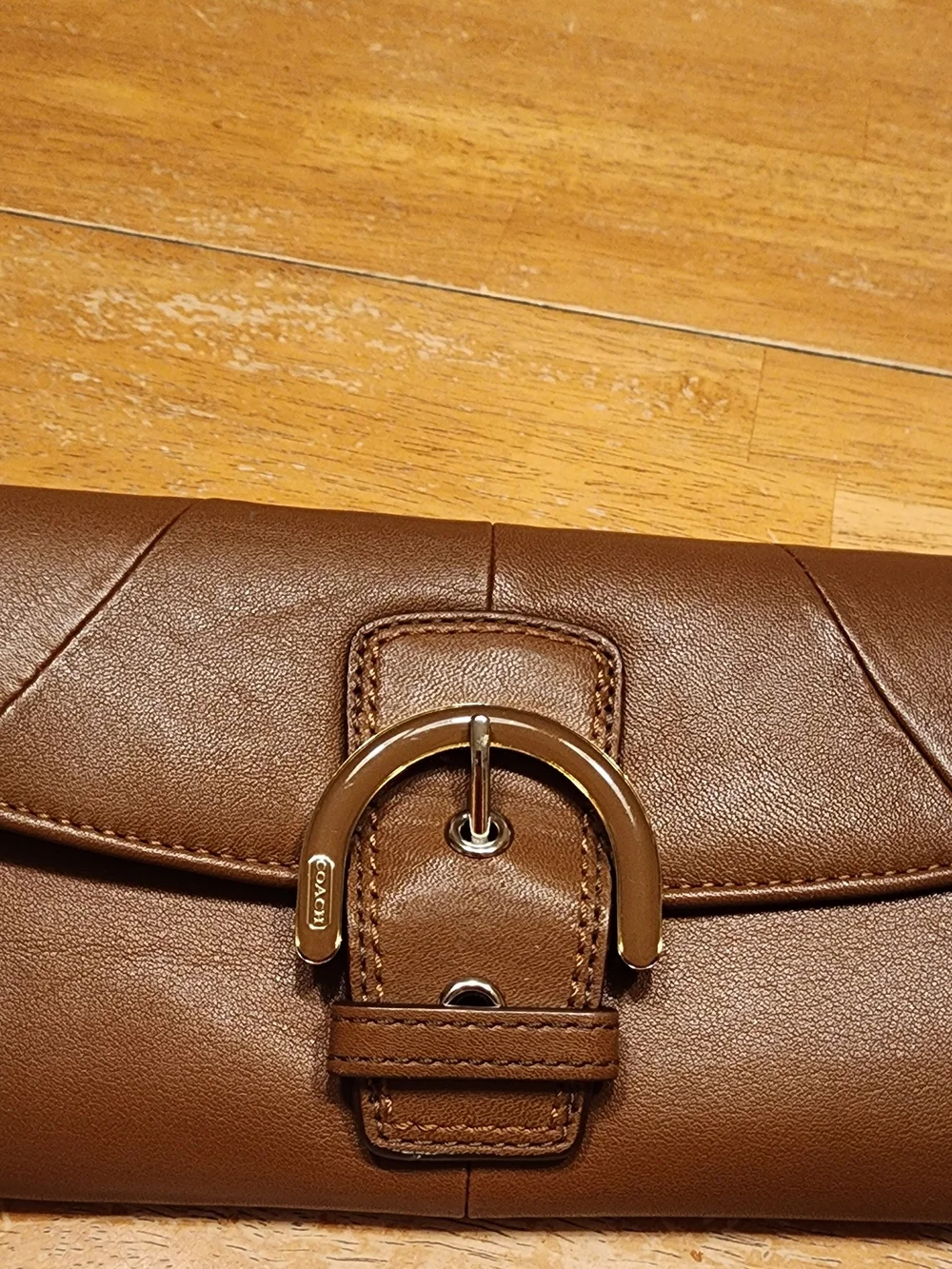 vintage Coach Soho Buckle Wallet crafted in brown leather prominent front Buckle